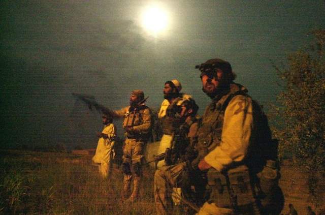<b>Members of the U.S. Army Special Forces keep close eye on the moon-lit perimeter of a compound, suspected of holding al-Qaida and Taliban forces, in August in Narizah, east of Kabul, Afghanistan. The units will stay in Afghanistan to fight terrorists. </b>